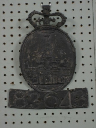 An oval lead fire mark surmounted by a crown, numbered  836438 10" ILLUSTRATED