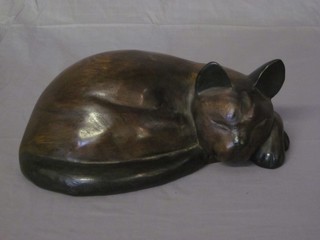 A carved hardwood figure of a curled sleeping cat 12"