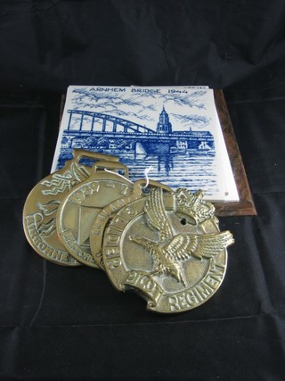A brass Glider Pilot Regt. plaque, an Airborne horse brass, 2 other horse brasses and 2 blue and white tiles