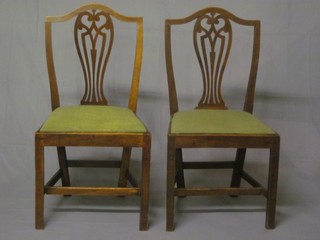 A pair of 18th/19th Century Chippendale style country elm dining chairs with vase shaped slat backs and upholstered seats