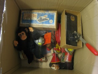 A box containing tin plate and other toys