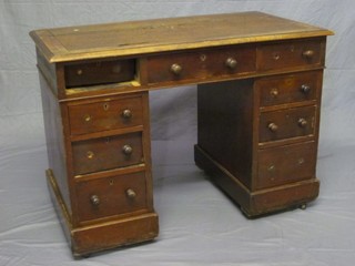 An Edwardian walnut kneehole pedestal desk with inset tooled writing surface, above 1 long and 8 short drawers 42"