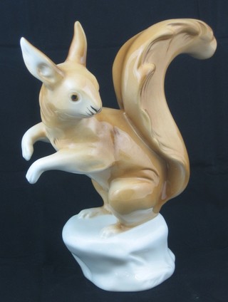A Royal Dux porcelain figure of a squirrel, the base with purple triangular mark 9"