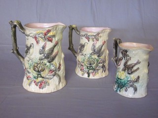 A set of 3 Victorian graduated Majolica jugs decorated birds and  a nest 6", the bottom with kite registration mark