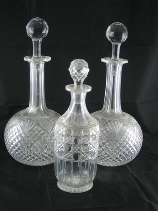 A pair of cut glass mallet shaped decanters and stoppers 12" and  a cut glass decanter 9"