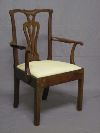 A Georgian mahogany Chippendale style carver chair with vase  shaped slat back and upholstered drop in seat, raised on square  supports