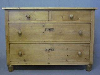 A Continental stripped and polished pine chest of 2 short and 2  long drawers with tore handles, raised on bun feet 41"
