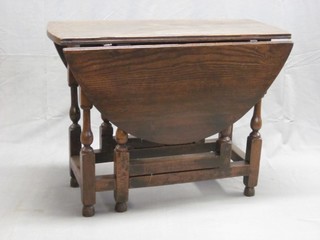 An 18th Century oak oval drop flap gateleg dining table, fitted a  frieze drawer and raised on turned supports 36"