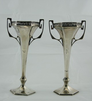 A pair of Art Nouveau octagonal waisted silver twin handled  vases, raised on spreading feet, Birmingham 1916, 7"