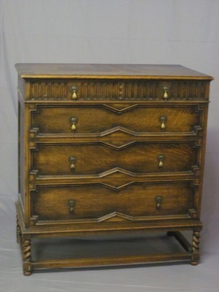 A 1930's Waring & Gillow oak Jacobean style chest of 2 short  and 3 long drawers, raised on spiral turned and block supports  37"