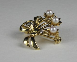 An 18ct yellow gold brooch of floral form set diamonds and  pearls
