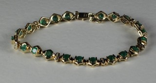 A 14ct yellow gold bracelet set emeralds