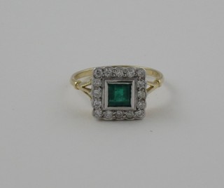 A lady's 18ct yellow gold dress ring set a square cut emerald surrounded by diamonds