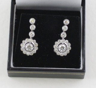 A pair of diamond cluster and drop earrings, approx 1.35ct
