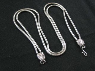 A modern silver double snake necklace