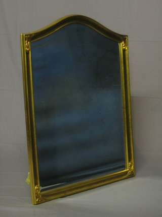 An arch shaped bevelled plate wall mirror contained in a decorative gilt frame 28"