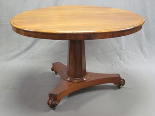 A William IV circular mahogany snap top Loo table, raised on a chamfered column with triform base 47"