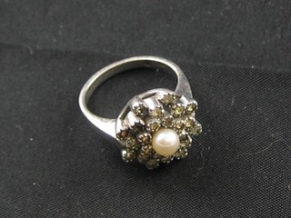 A silver filigree dress ring set a pearl