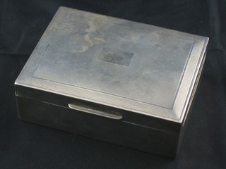 A modern rectangular silver cigarette box with engine turned decoration and hinged lid, Birmingham, 4 1/2"
