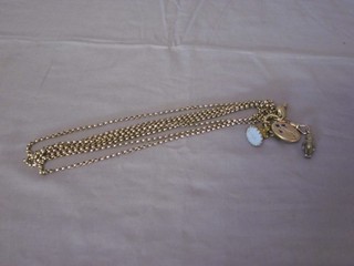 A gilt metal belcher link guard chain hung a metal and woven  hair locket, a seal and a silver figure of a child