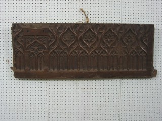 A 17th/18th Century carved oak panel with arcaded decoration  40" x 15"