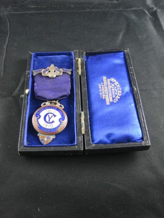 A silver gilt and enamelled Old Fellows jewel