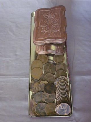 A carved wooden trinket box with hinged lid and a collection of  pennies
