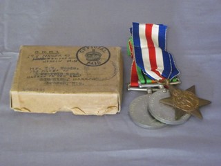 A group of 3 medals comprising France and Germany Star,  Defence and War medal together with original cardboard package  to T W Woods,