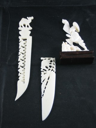 A carved ivory figure of a standing fisherman and 2 carved ivory  paper knives