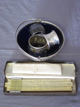 An Eastern engraved silver napkin ring, an Eastern napkin ring  and 1 other, a silver plated bowl with blue glass liner and a slide  rule