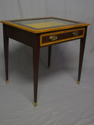 A rectangular inlaid mahogany bijouterie table, fitted a drawer and raised on square tapering supports ending in brass caps and castors 29"