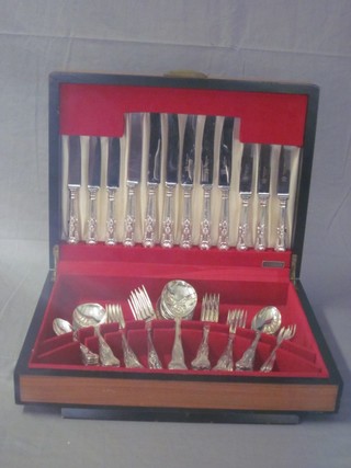 A canteen of silver plated Kings Pattern flatware contained in a walnut canteen box
