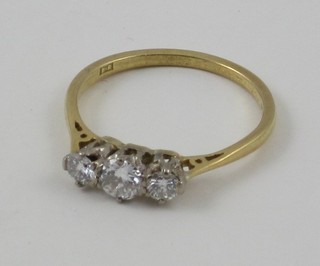 A lady's 18ct gold dress ring set 3 diamonds