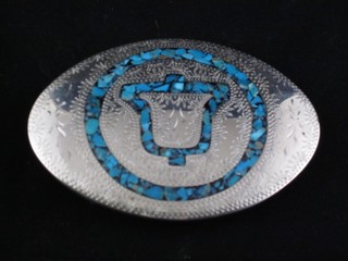 An oval "silver" and inlaid blue hardstone buckle, made for The Bell Telephone Company