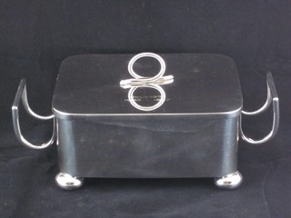A rectangular silver plated twin handled sardine dish raised on bun feet, no liner