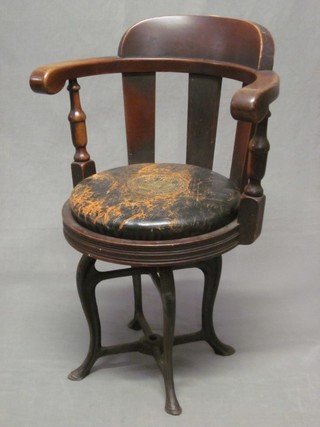 A Victorian mahogany tub back ships chair, raised on iron supports, the leather seat marked - The Association of The British Chambers of Commerce
