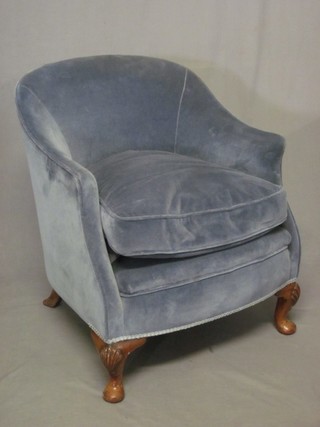 A Queen Anne style walnut tub back armchair upholstered blue material, raised on cabriole supports