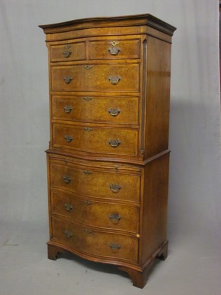 A Queen Anne style figured walnut chest on chest with moulded cornice, the upper section with canted cornice fitted 2 short drawers above 3 long drawers, the base fitted a brushing slide above 3 long drawers, raised on bracket feet 28"