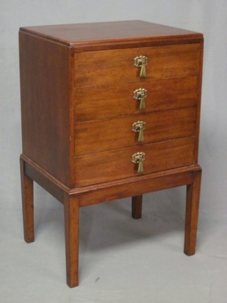 A walnut bedside chest of 4 long drawers, raised on square tapering supports 18"