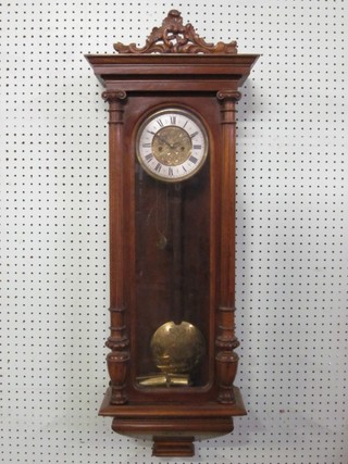 A striking Vienna style regulator with 6" silvered dial having Roman numerals and contained in a walnut case