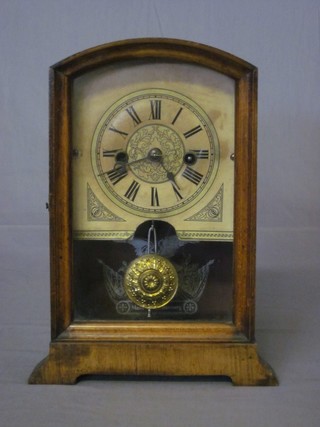 An American striking shelf clock with paper dial and Roman numerals contained in an arched walnut case 6 1/2"