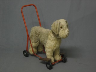 A childs metal and wooden push-a-long figure of a dog