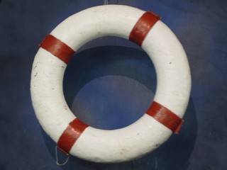 A circular white and red life ring