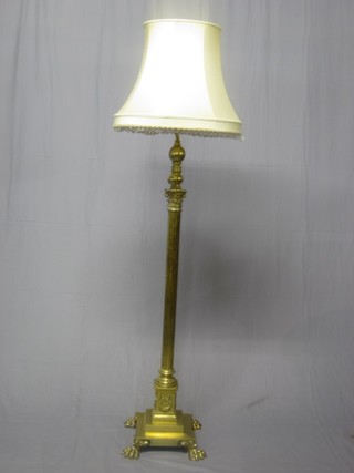 A handsome brass reeded standard lamp with Corinthian column capital