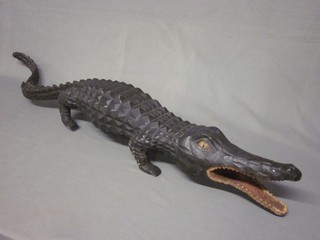 A carved wooden figure of a crocodile, foot f,