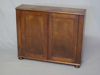 A 19th Century mahogany hanging cabinet, the interior fitted shelves enclosed by panelled doors 32"