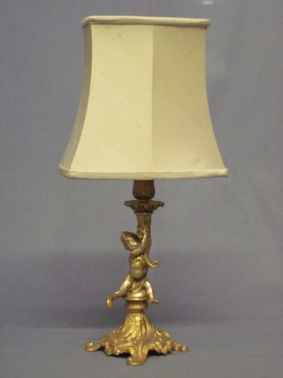A gilt metal electric table lamp supported by a figure of a cherub 10"