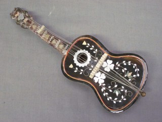 A tortoiseshell musical box in the form of a guitar 8"