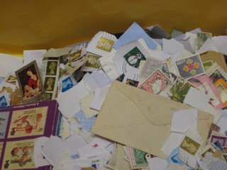 A yellow plastic crate containing a collection of various stamps