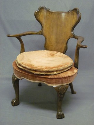 A Queen Anne style walnut tub back open arm chair with upholstered seat, raised on cabriole ball and claw supports